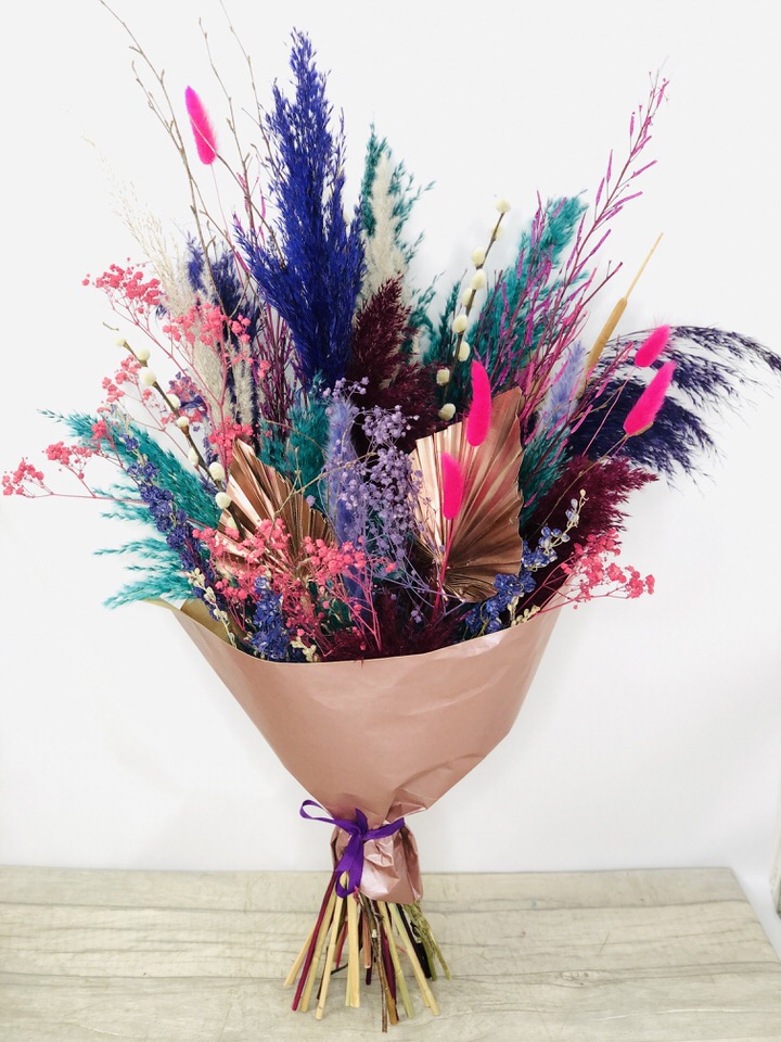 <h2>Hand-Tied Bouquet of Dried Flowers</h2>
<p>This bouquet of dried flowers is hand-arranged by our professional Florists. Containing 2 Copper Palm Spears 3 Navy Pampas 2 Grey Pampas 3 Small Burgundy Pampas 3 Dried Larkspur 2 Reeds 3 Pussy Willow 5 Mustard Grass 6 Pink Bunny Tails 2 Dried Pink Gypsy Grass 1 Dried Purple Gypsy Grass 3 Birch 4 Teal Pampas and 3 Mini Blue Pampas Grass.</p>
<p>This dried bouquet would look lovely to decorate your home and as they are dried flowers they would last forever - perfect to just pop into a vase (no water required!)</p>
<p>Our dried flowers are a natural, dried, and sometimes dyed product, so some transference may occur. Please ensure the flowers remain dry. If placed in direct light, some fading may occur.</p>
<h2>Flower Delivery Coverage</h2>
<p>Our shop delivers flowers and gifts to the following Liverpool postcodes L1 L2 L3 L4 L5 L6 L7 L8 L11 L12 L13 L14 L15 L16 L17 L18 L19 L24 L25 L26 L27 L36 L70 If your order is for an area outside of these we can organise delivery for you through our network of florists. We will ask them to make as close as possible to the image but because of the difference in stock and sundry items, it may not be exact.</p>
<h2>Dried Flowers | Everlasting Flowers </h2>
<p></p>
<p>Dried Flowers are a great alternative to fresh flowers. Dried flowers can last years when cared for properly, making them an ideal finishing touch to the interior design of any room. The advantage of having a hand-tied bouquet arranged by our Florists means they can just be put directly into a vase without any arranging and no water!</p>
<p>Dried Flowers are a big new trend and are a stylish and sustainable product that makes the perfect gift, or a treat for yourself.</p>
<p>From the simplest small gestures to spectacular blooms, dried flowers come in many wonderful colours and styles, with all budgets catered for.</p>
<h2>Eco-Friendly Liverpool Florists</h2>
<p>As florists we feel very close earth and want to protect it. Plastic waste is a huge problem in the florist industry so we made the decision to make our packaging eco-friendly.</p>
<p>To achieve this, we worked with our packaging supplier to remove the lamination off our boxes and wrap the tops in an Eco Flowerwrap, which means it easily compostable or can be fully recycled.</p>
<p>All our bouquets have small wooden ladybird hidden amongst them, so do not forget to spot the ladybird and post a picture on our social media pages to enter our rolling competition.</p>
<h2>Liverpool Flower Delivery</h2>
<p>We are open 7 days a week and offer advanced booking flower delivery, same-day flower delivery, 3-hour flower delivery. Guaranteed AM  Flower Delivery and also offer Sunday Flower Delivery.</p>
<p>Our florists deliver in Liverpool and can provide flowers for you in Liverpool, Merseyside. And through our network of florists can organise flower deliveries for you nationwide with Interflora.</p>
<h2>The Best Florist in Liverpool, your local Liverpool Flower Shop</h2>
<p>Come to Booker Flowers and Gifts Liverpool for your beautiful dried flowers, fresh flowers, and plants. For that bit of extra luxury, we also offer a lovely range of finishing touches, such as wines, champagne, locally crafted Gin and Rum, vases, Scented Candles and Chocolates that can be delivered with your flowers.</p>
<p>To see the full range, see our extras section.</p>
<p>You can trust Booker Flowers and Gifts of delivery the very best for you.</p>
<p><em>5 Star review on Yell.com</em></p>
<p><em>Thank you Gemma for your fabulous service. The flowers are of the highest quality and delivered with a warm smile. My sister was delighted. Ordering was simple and the communications were top-notch. I will definitely use your services again.</em></p>